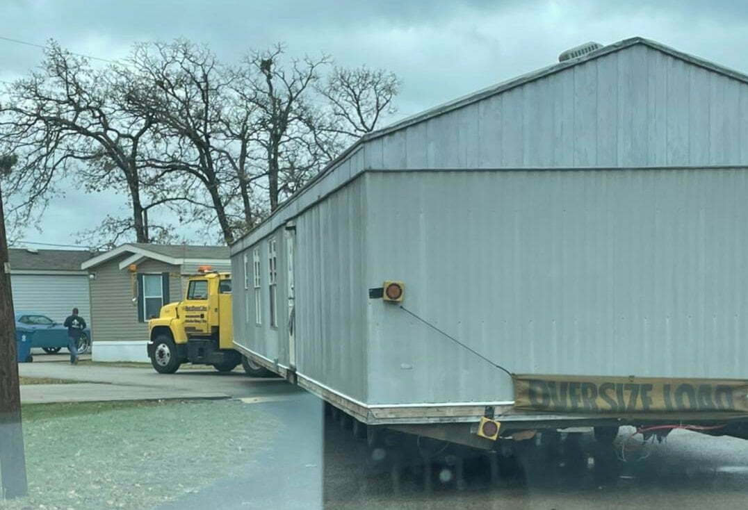 Mobile home being transported on truck in Henderson, Texas